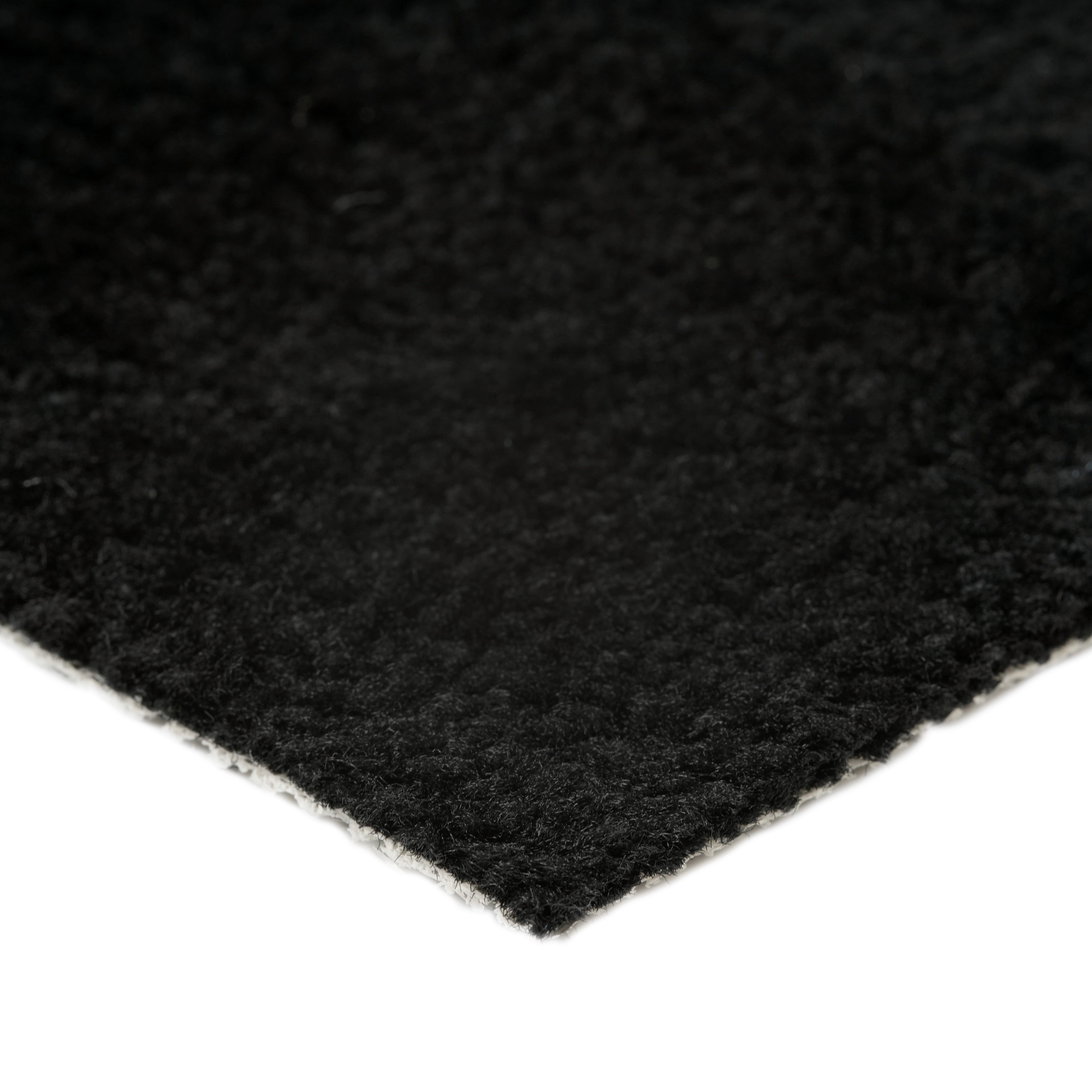Soft black area rug with a plush texture, ideal for enhancing home decor and comfort.