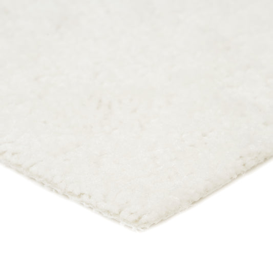 Soft white area rug, plush texture, ideal for cozy home decor. Perfect for living rooms or bedrooms.