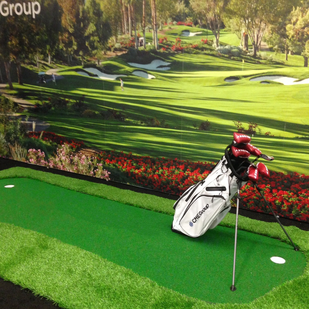 Indoor putting green with synthetic grass and golf bag, perfect for practicing golf skills at home.