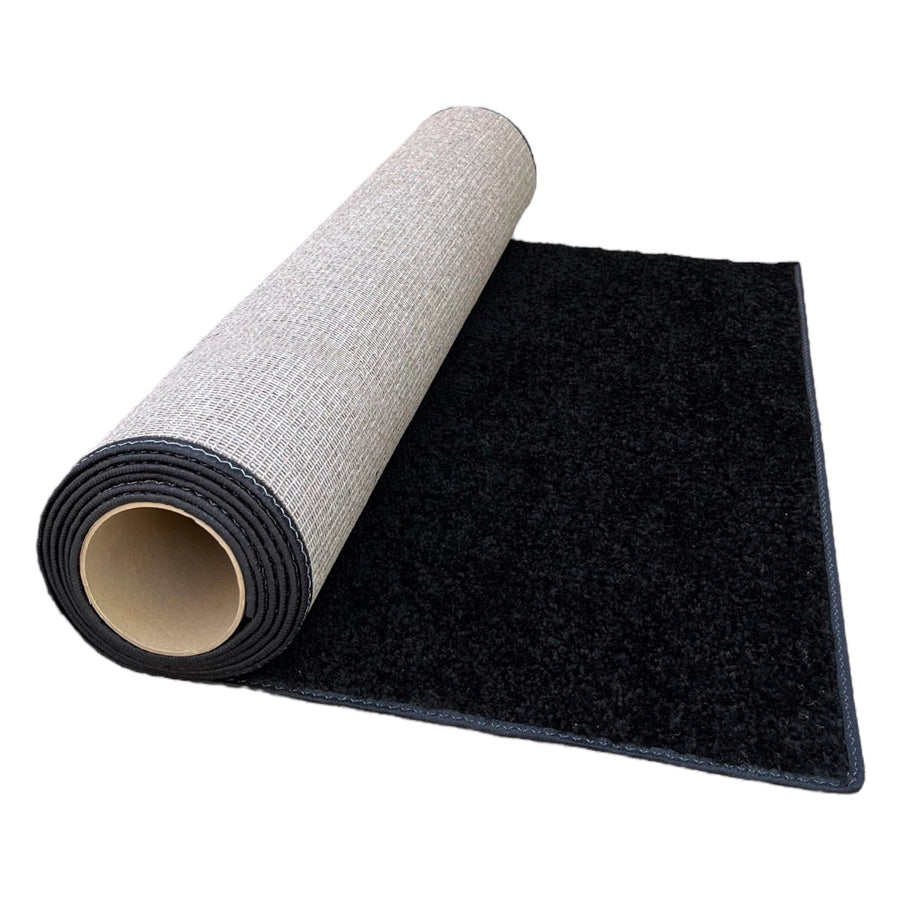 Black plush carpet rug roll with a textured backing, perfect for indoor flooring decor.