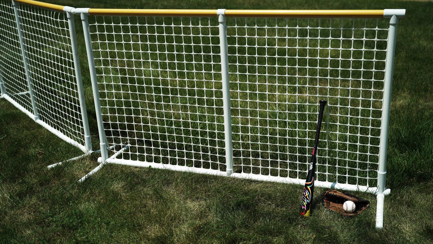 Colorful baseball bat leaning against a white net, with a glove and ball on the grass.