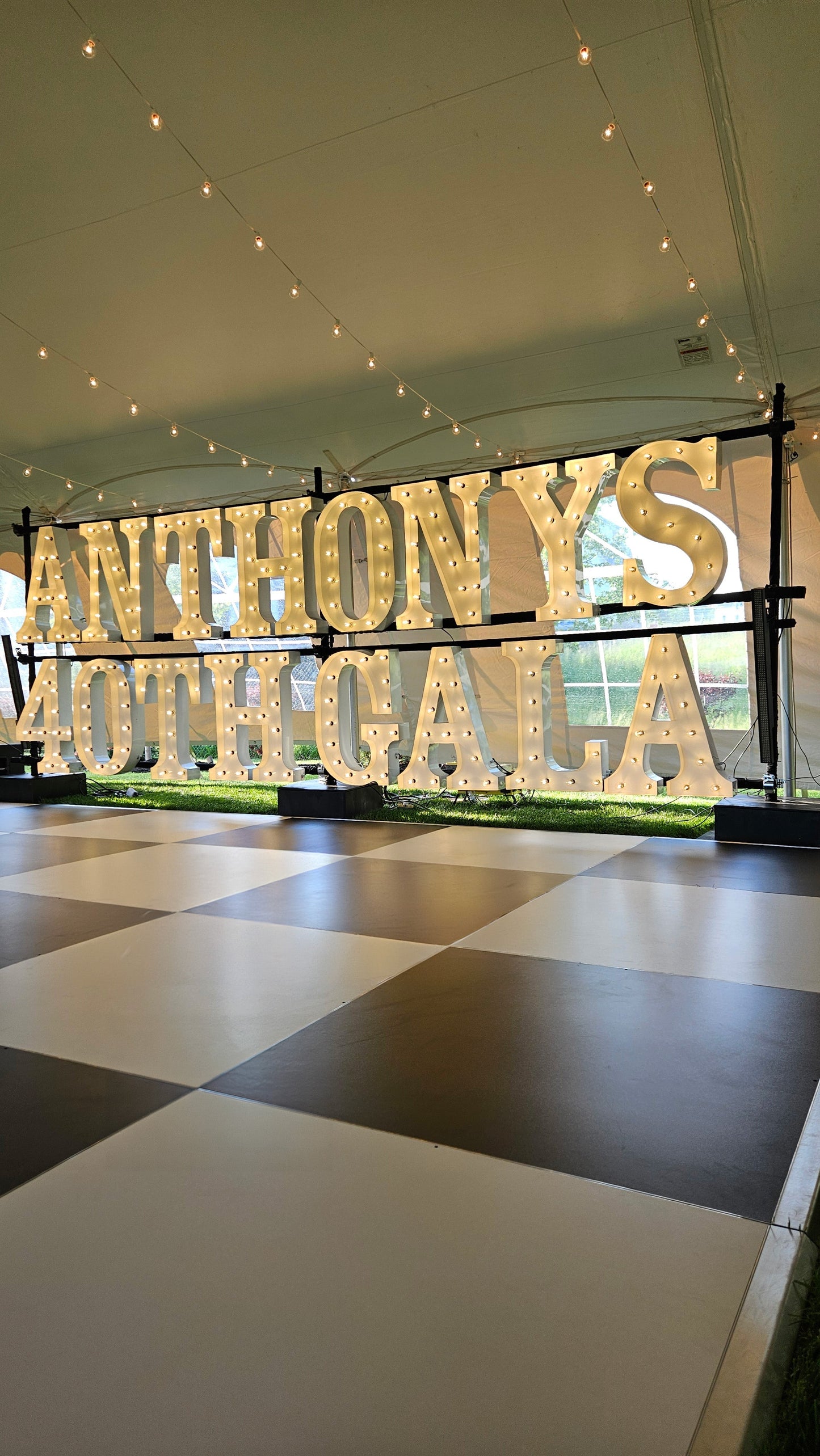 Illuminated marquee sign for Anthony's 40th gala, featuring bright bulbs and a festive design.