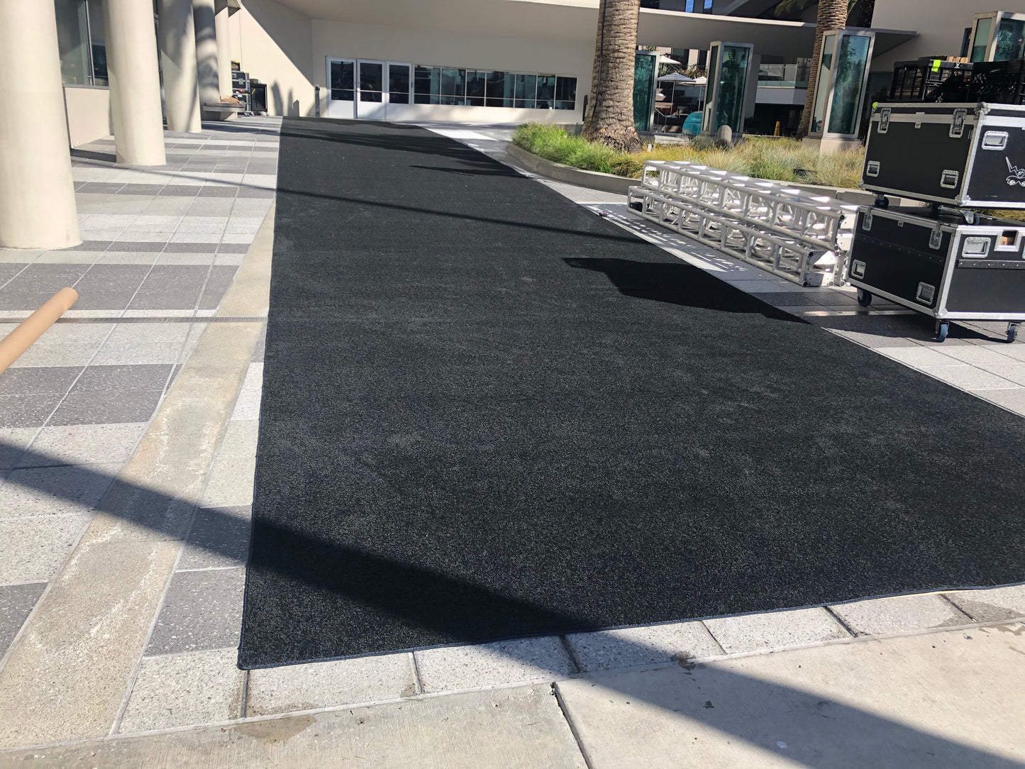 Black outdoor carpet mat for events, providing a smooth surface for walkways in commercial settings.