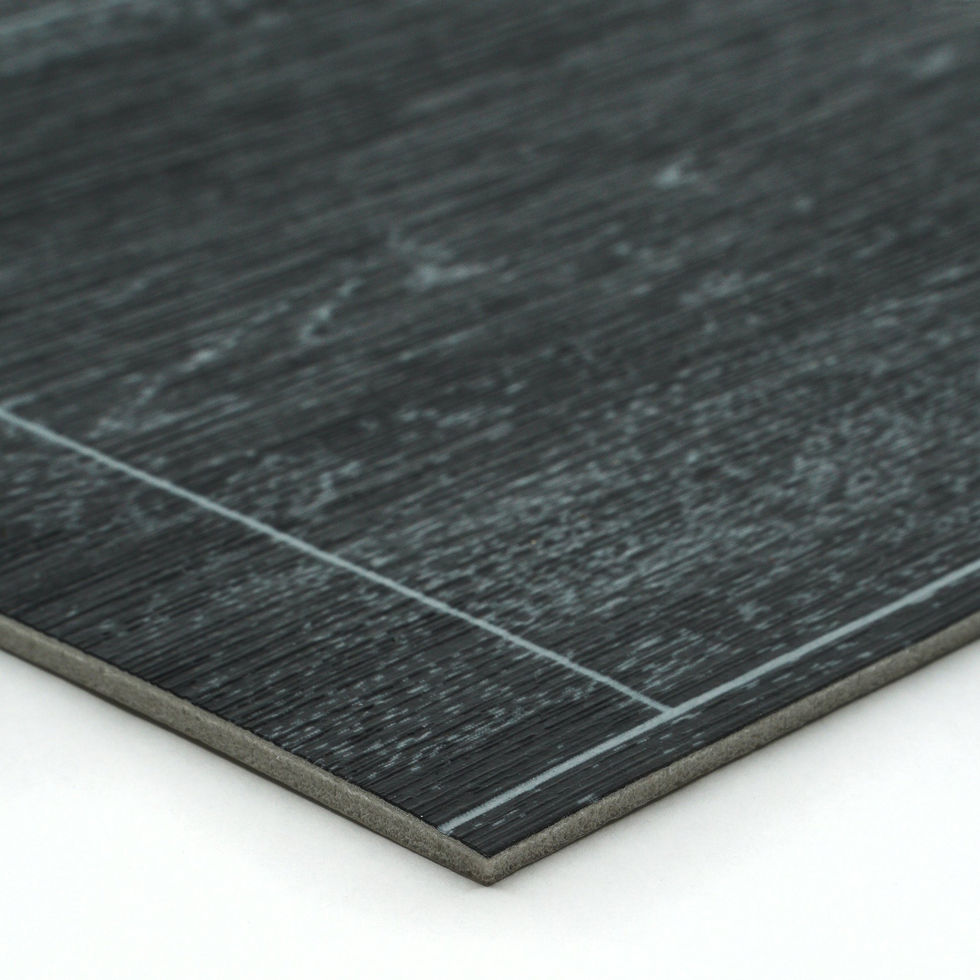 Dark gray laminate flooring with textured wood finish and smooth edge, ideal for modern interiors.