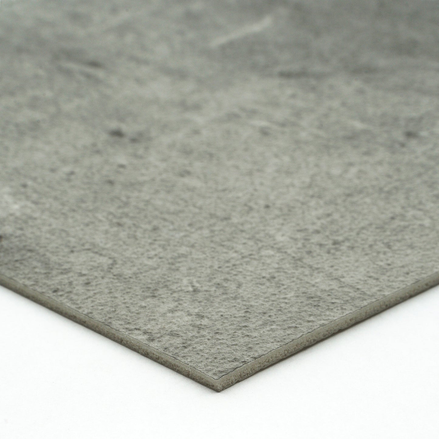 Gray textured stone slab, ideal for flooring or countertops, made from durable composite material.