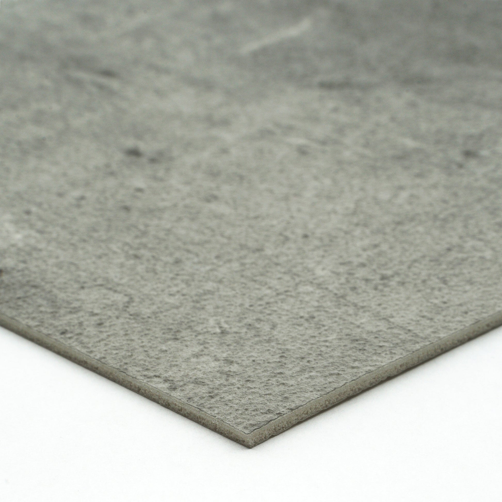 Gray textured stone slab, ideal for flooring or countertops, made from durable composite material.