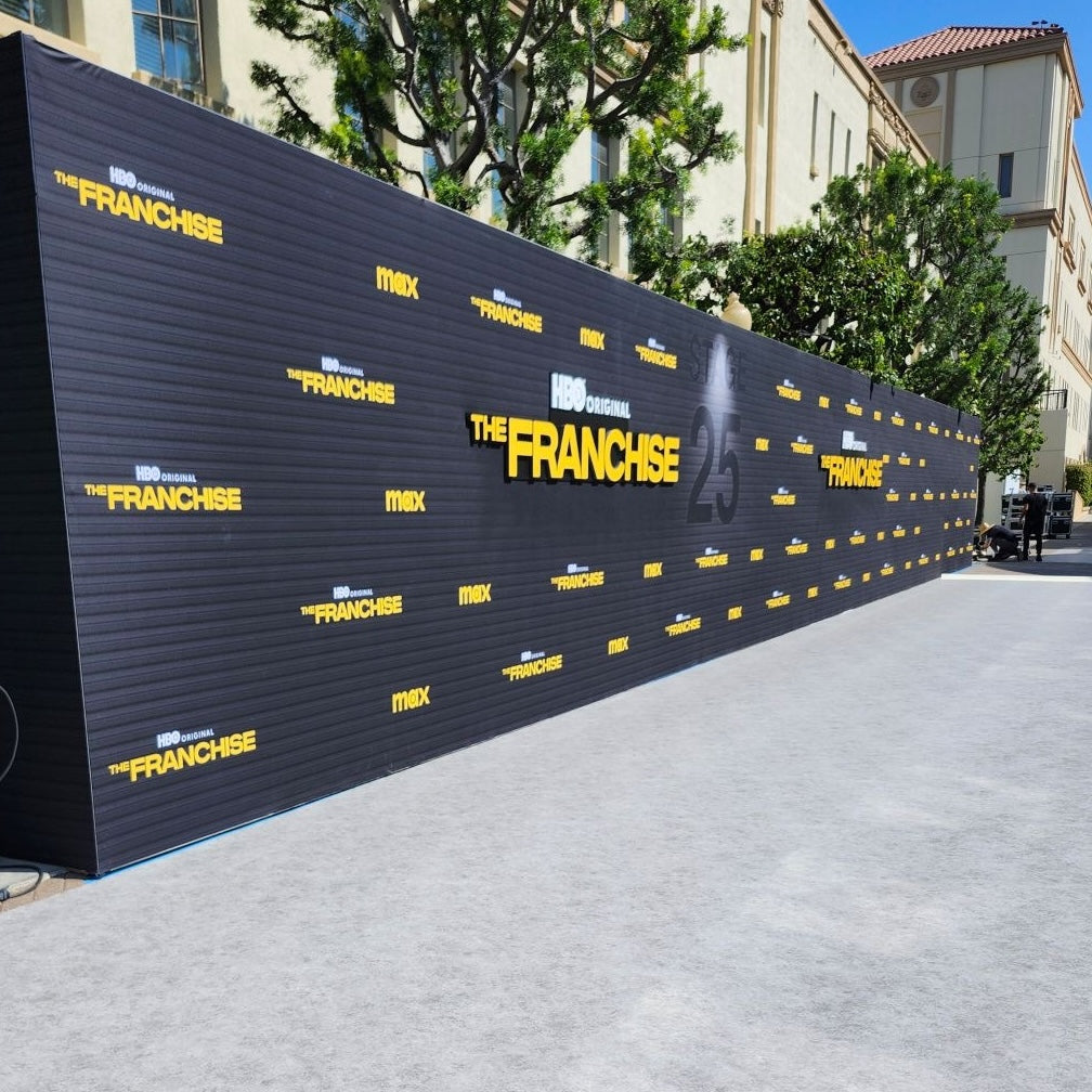 HBO original 'The Franchise' promotional wall, black with yellow text, outdoor event backdrop.