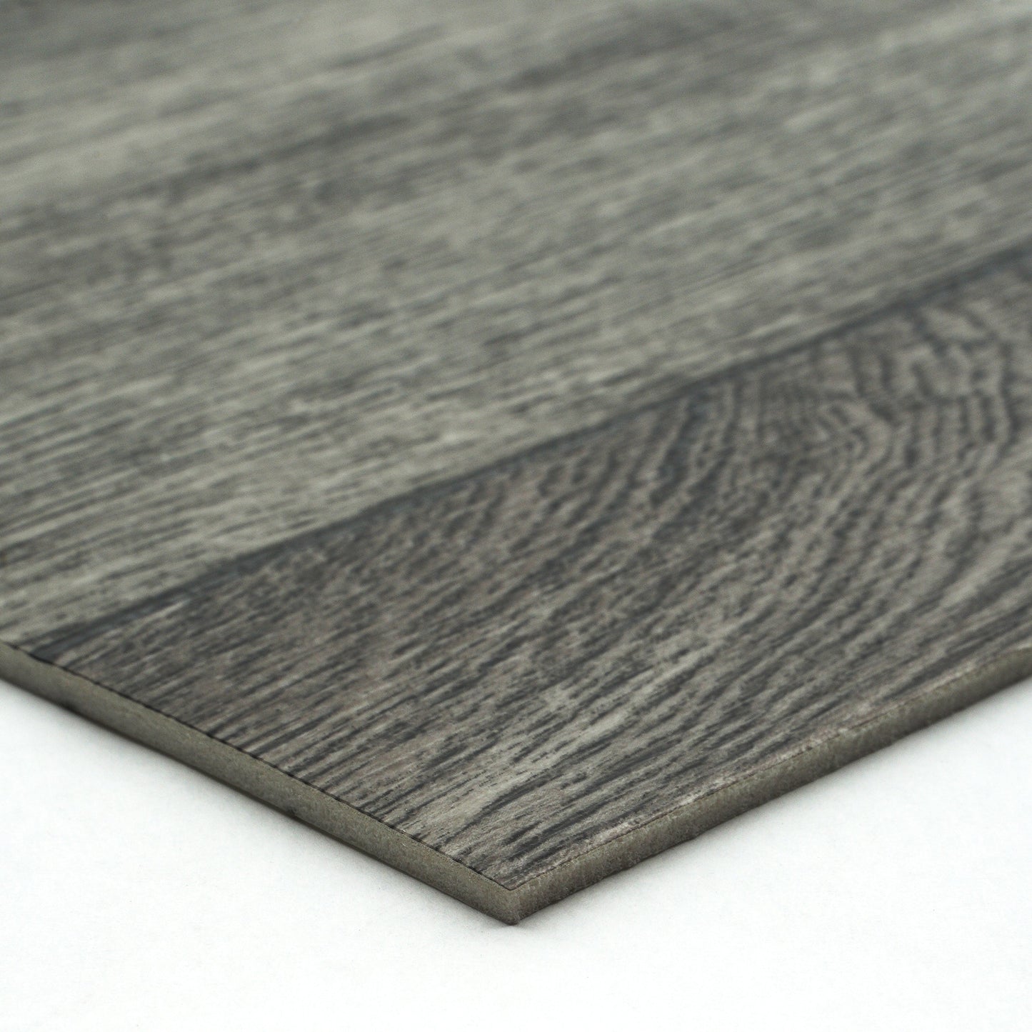 Gray laminate flooring plank with wood grain texture and sleek edge design for modern interiors.