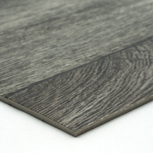 Gray laminate flooring plank with wood grain texture and sleek edge design for modern interiors.