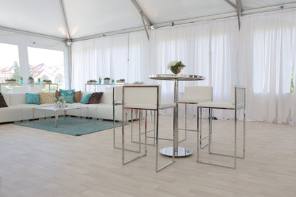 Modern white bar stools and table with chrome accents in a stylish event space.
