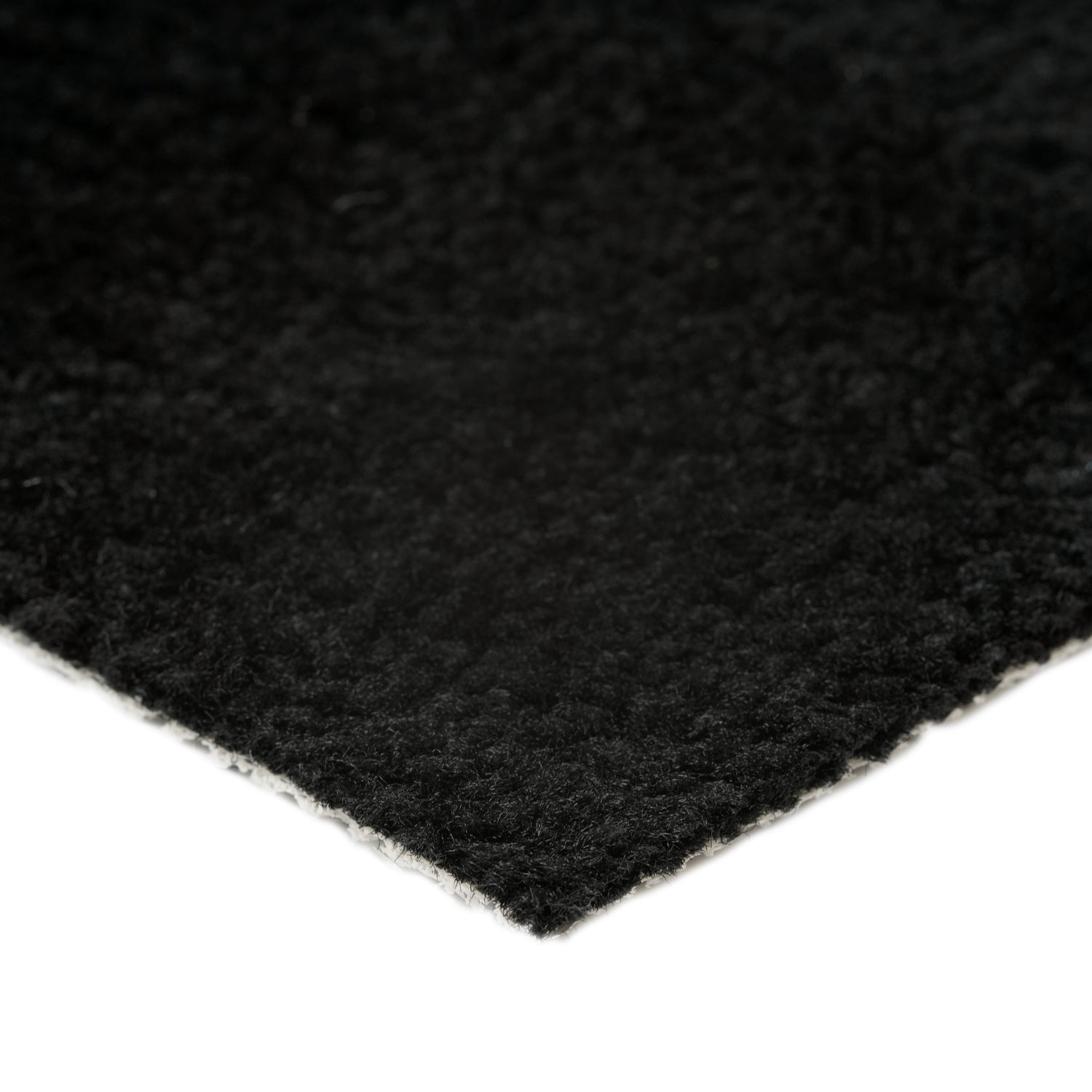 Soft black area rug with a plush texture, ideal for enhancing home decor and comfort.