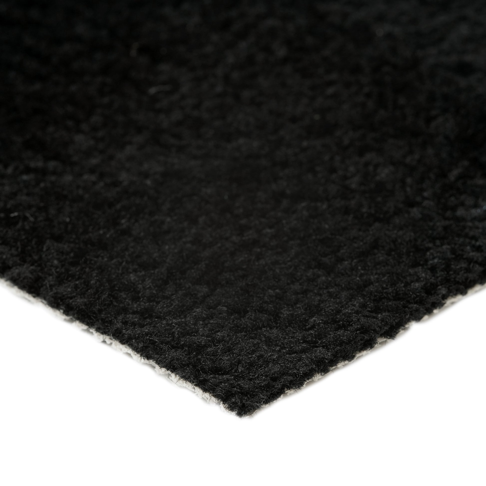 Soft black area rug with a plush texture, ideal for enhancing home decor and comfort.