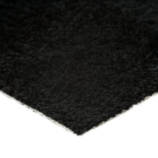 Soft black area rug with a plush texture, ideal for enhancing home decor and comfort.