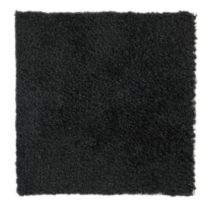 Soft black shag rug, plush texture, ideal for adding warmth to any room.