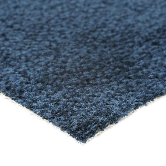 Soft navy blue carpet with textured surface, perfect for adding warmth to any room.