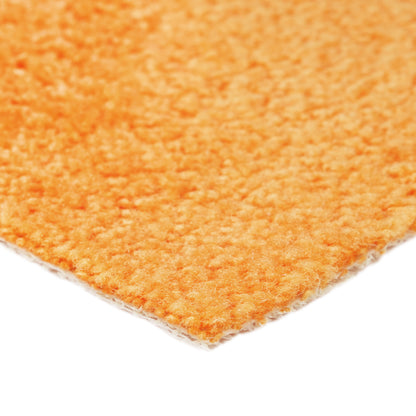 Vibrant orange plush rug with soft texture, perfect for adding warmth to any room.