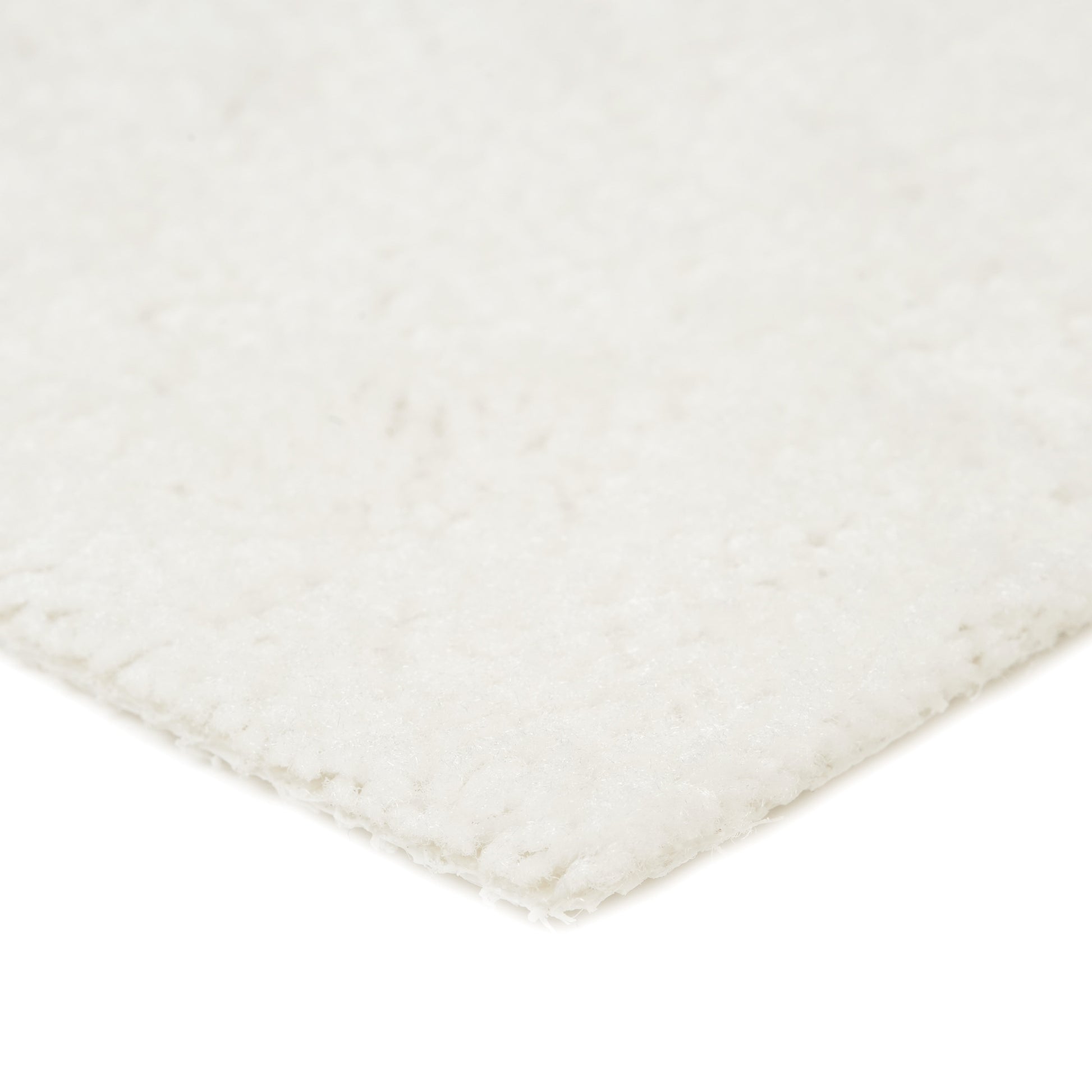 Soft white area rug, plush texture, ideal for cozy home decor. Perfect for living rooms or bedrooms.
