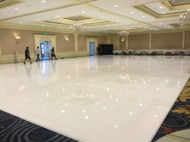 Shiny white dance floor in an elegant event space, ideal for weddings and receptions.