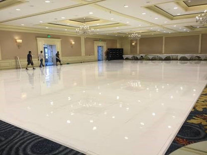 Shiny white dance floor in an elegant event space, ideal for weddings and receptions.