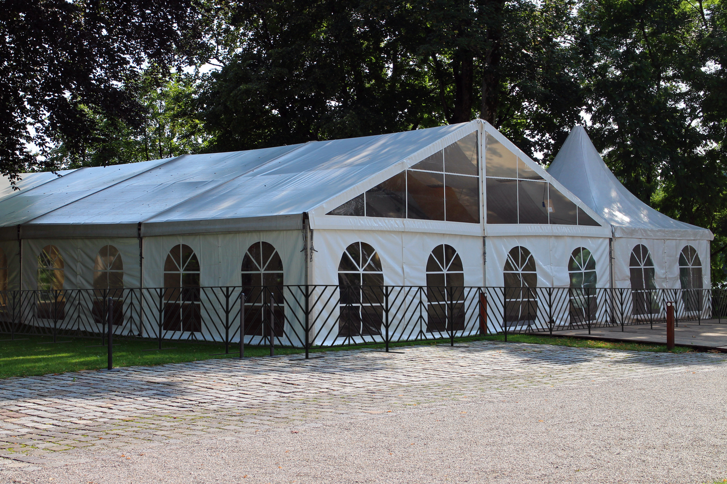 Large white outdoor party tent with windows, perfect for events, weddings, and gatherings.