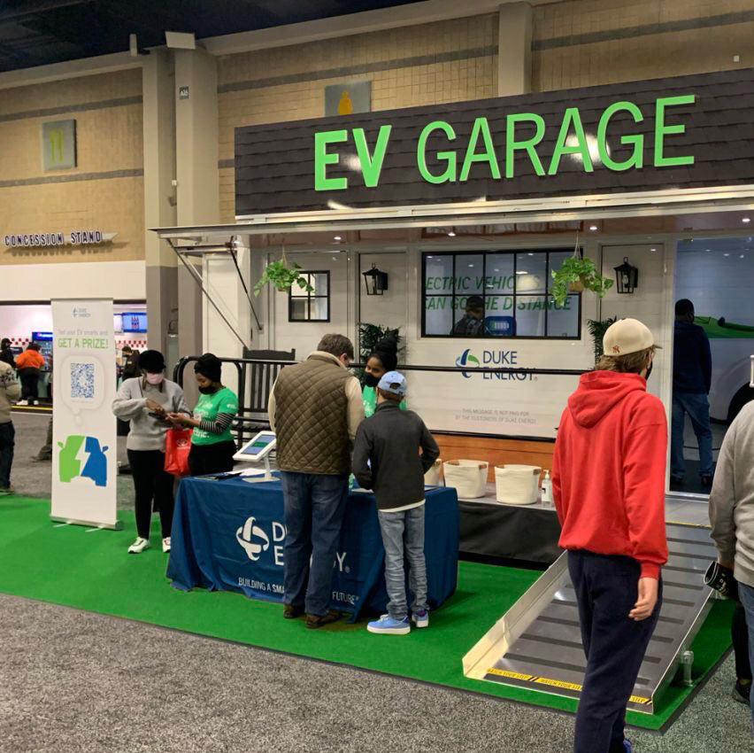 Duke Energy EV Garage booth showcasing electric vehicle charging solutions at a trade show.