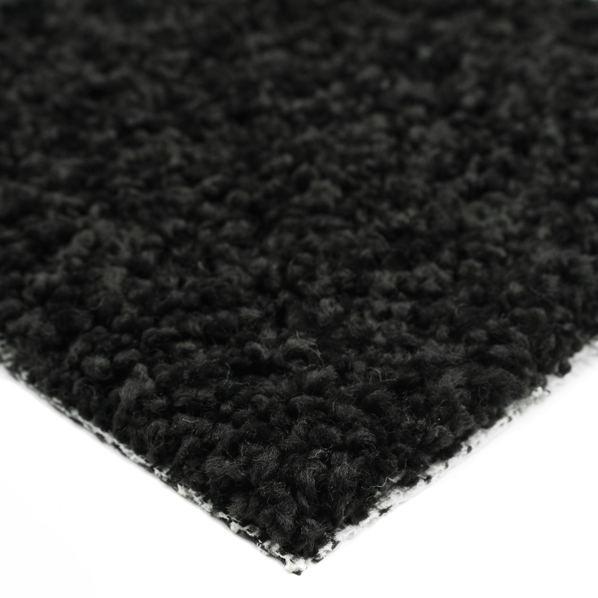 Soft black shag rug with plush texture, perfect for adding warmth to any room.