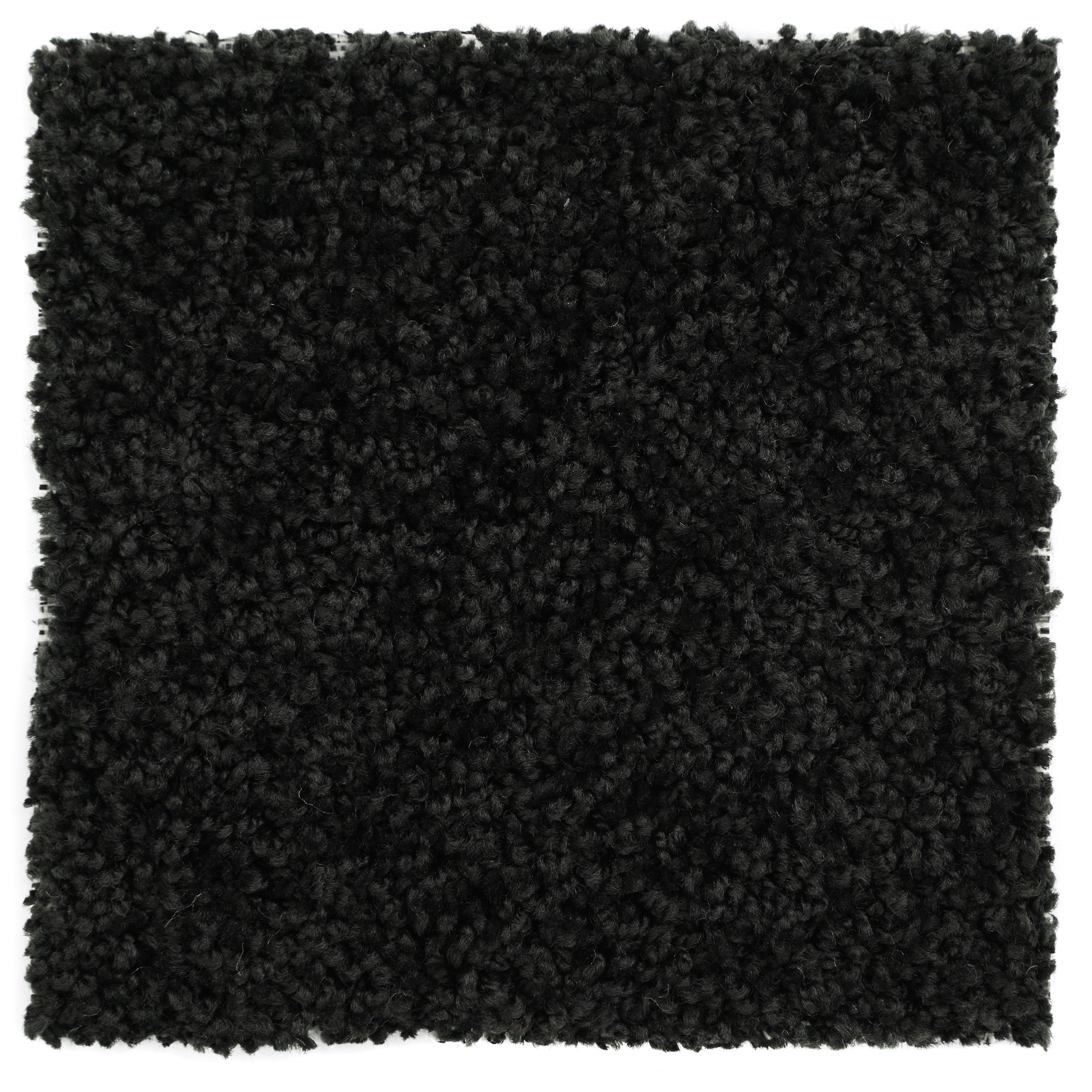 Black plush area rug, soft synthetic material, perfect for modern home decor and cozy ambiance.
