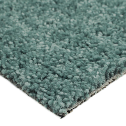 Soft teal shag rug, plush texture, perfect for adding warmth and style to any room.