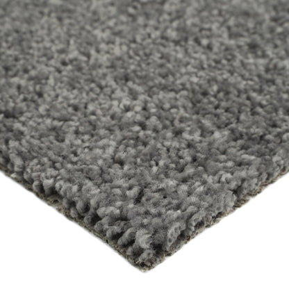 Soft gray shag rug, plush texture, ideal for living room or bedroom, adds warmth and comfort to any space.