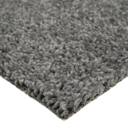 Soft gray shag rug, plush texture, ideal for living room or bedroom, adds warmth and comfort to any space.