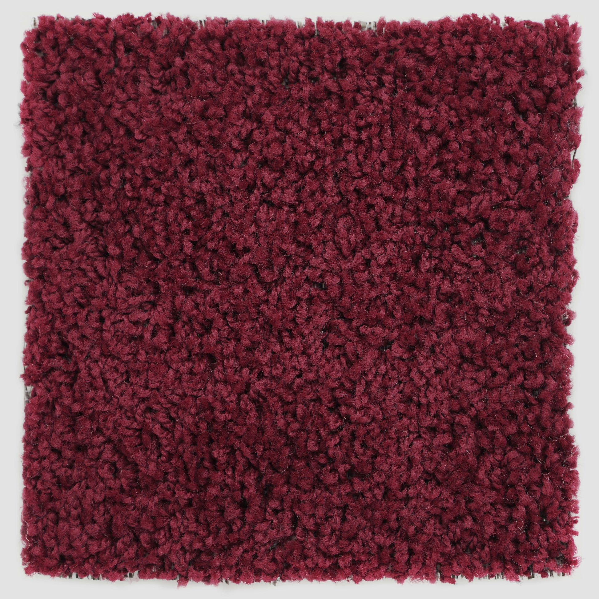 Plush burgundy area rug, soft texture, perfect for adding warmth to any room.