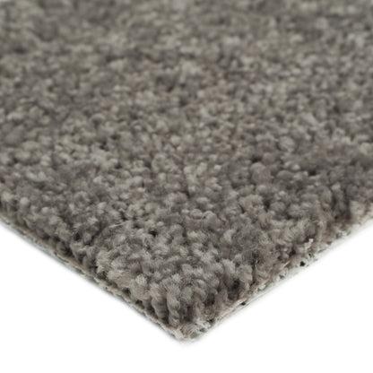 Soft gray shag rug with thick fibers, perfect for cozy living spaces.