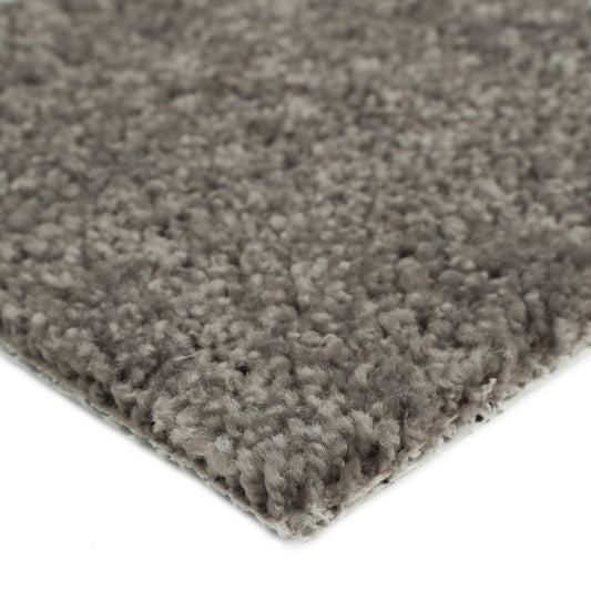 Soft gray shag rug with thick fibers, perfect for cozy living spaces.