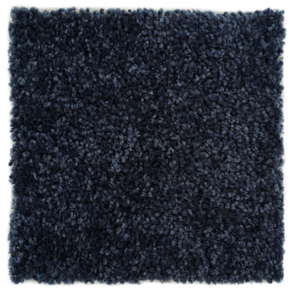 Plush navy blue shag rug made of soft synthetic fibers, perfect for adding warmth and style to any room.