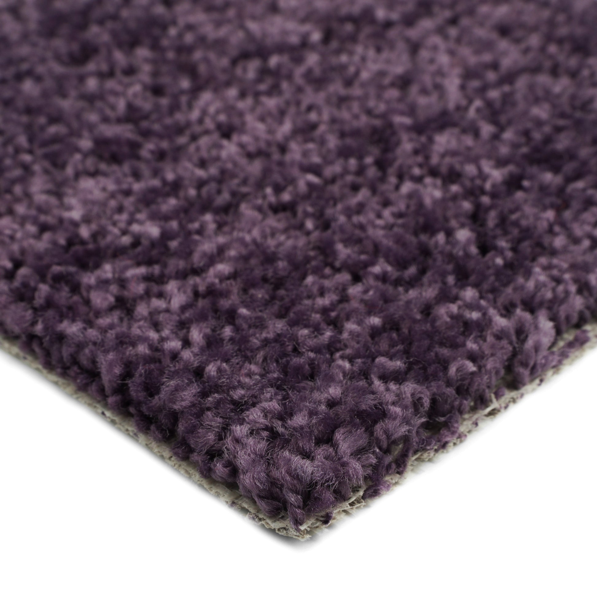 Plush purple area rug, soft synthetic fibers, ideal for cozy home decor and comfort.