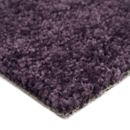 Plush purple area rug, soft synthetic fibers, ideal for cozy home decor and comfort.