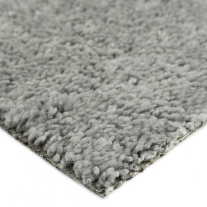 Soft gray shag area rug, dense pile, cozy texture, ideal for living rooms or bedrooms.
