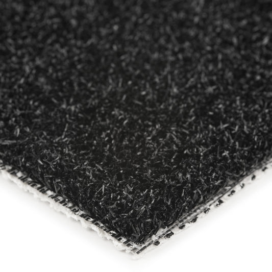 Close-up of a black synthetic turf mat with textured surface for outdoor use.