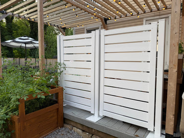 Stylish white wooden privacy panels, slatted design, perfect for outdoor gardens and patio spaces.