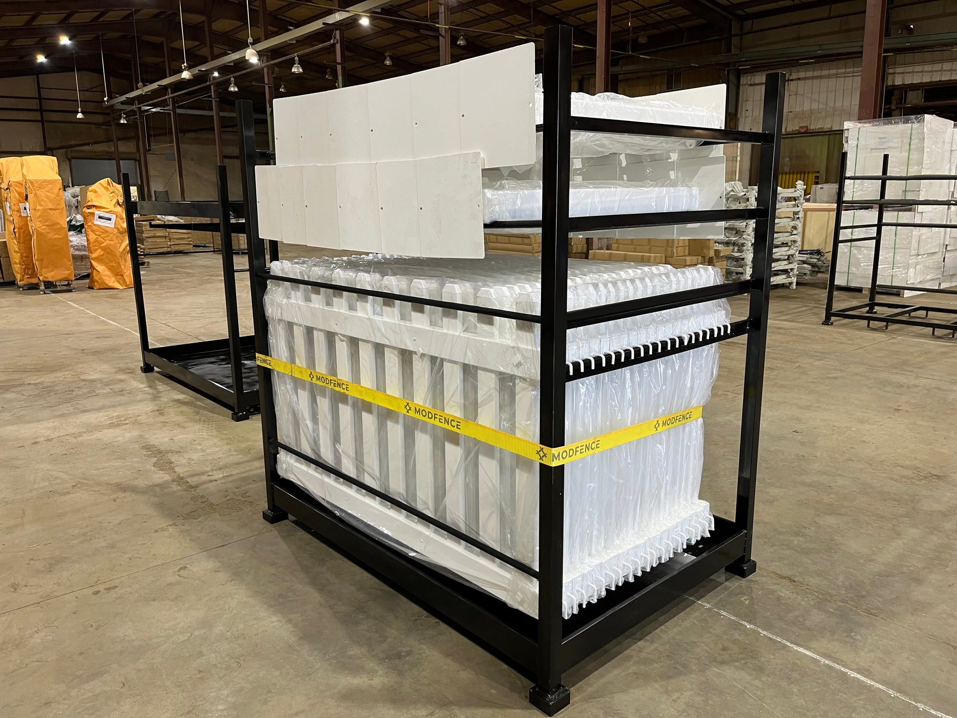 Black metal storage rack with stacked white products, perfect for organization in warehouses.