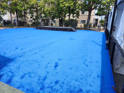 Bright blue artificial turf sports surface, ideal for outdoor activities and events.