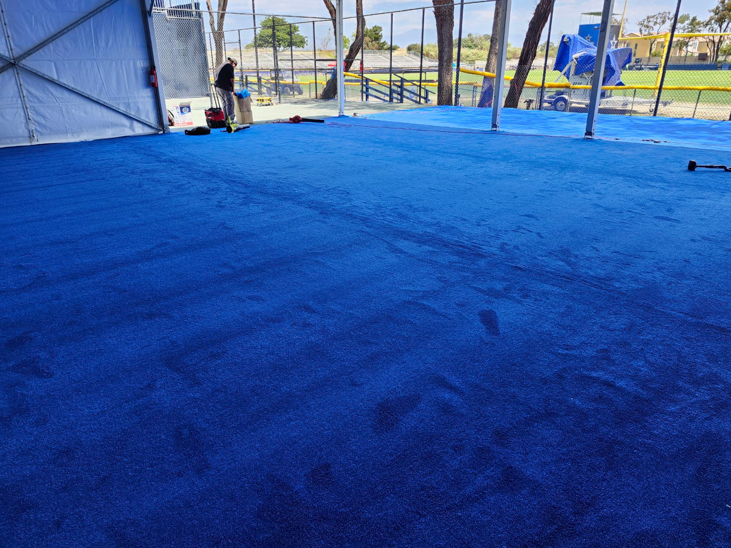 Vibrant blue synthetic turf flooring, ideal for sports and outdoor events.