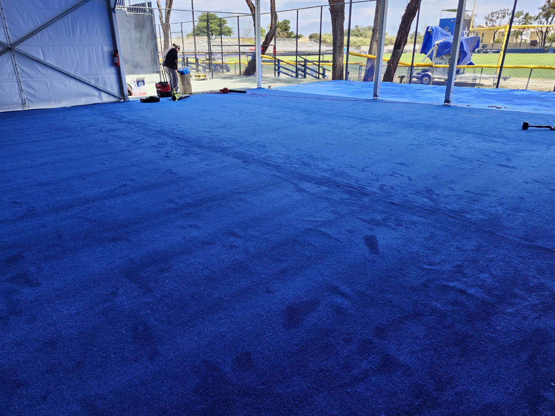 Vibrant blue synthetic turf flooring, ideal for sports and outdoor events.