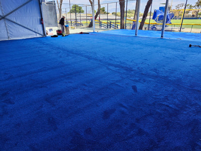 Vibrant blue synthetic turf flooring, ideal for sports and outdoor events.