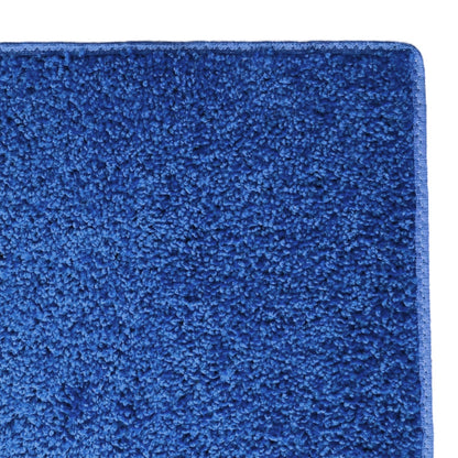 Soft plush blue area rug, ideal for cozy interiors, featuring a deep pile for added comfort.