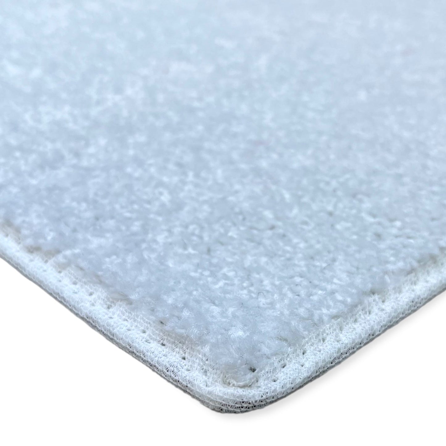 Soft white area rug, plush material with durable edges, perfect for enhancing home decor.