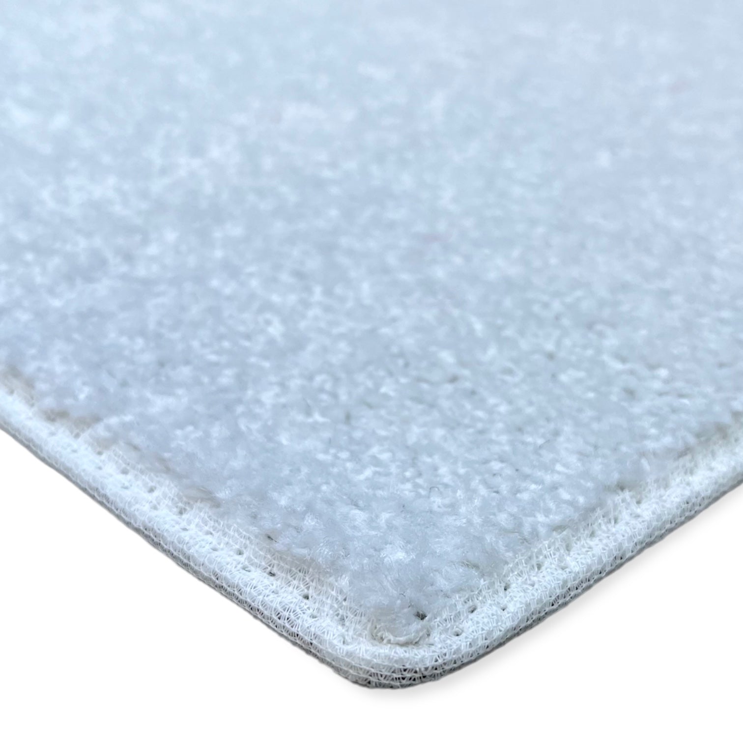 Soft white area rug, plush material with durable edges, perfect for enhancing home decor.
