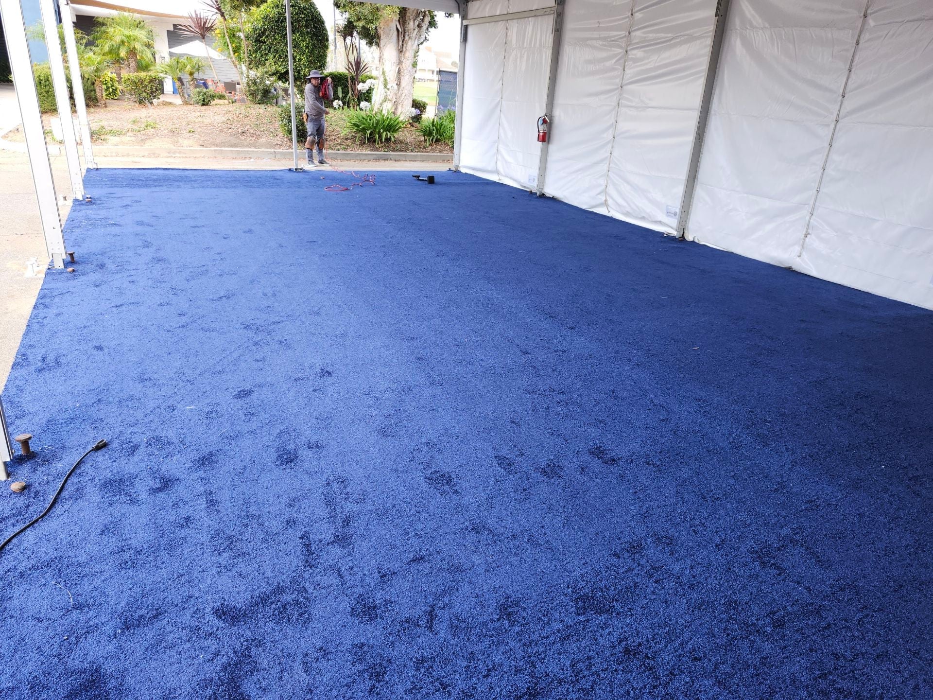 Soft blue carpet flooring in a tent setup, ideal for events and gatherings.