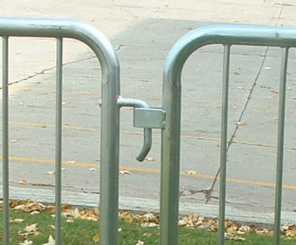Metal crowd control barrier with a secure latch, gray color, ideal for event management and safety.